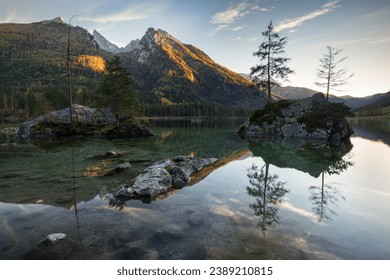 Moody reflection of the mountains on the Hintersee lake in Germany at sunset  - Powered by Shutterstock