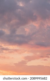 Moody sunset or sunrise sky with rays of light illuminating dark blue and bright and soft pink and orange clouds. no people, clouds only. High contrasts in a stormy sky - Shutterstock ID 2089995682