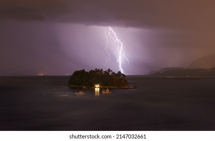 Moody Weather. Shot Of Lightning Hitting A Small Island In A Night Time Storm.