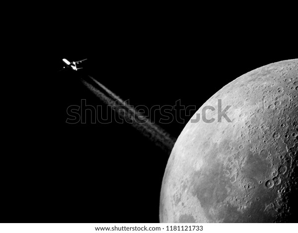 Moon and airplane\
contrails as background