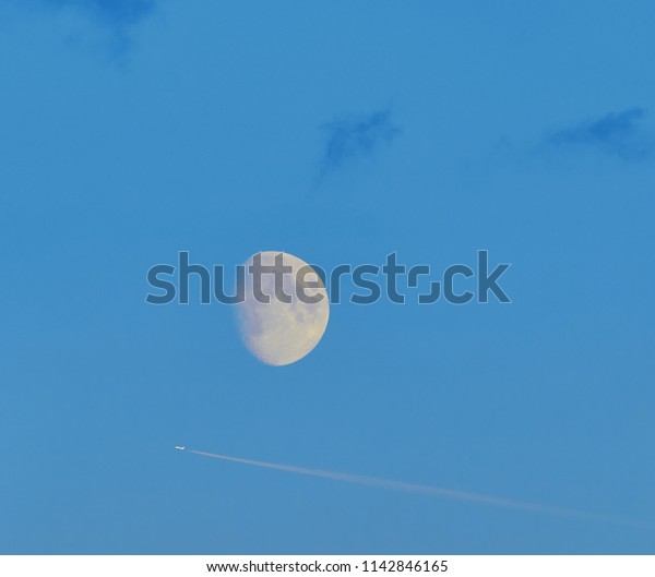 moon and airplane in the\
sky