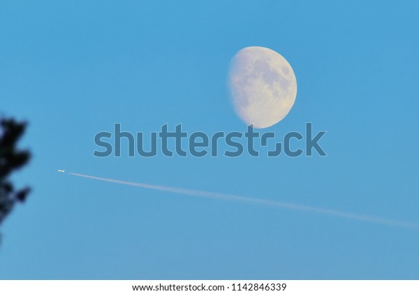 moon and airplane in the\
sky