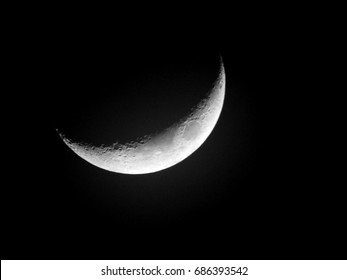 Moon background / The Moon as it appears early in its first quarter or late in its last quarter, when only a small arc-shaped section of the visible portion is illuminated by the Sun. 