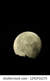 Moon behind mountain