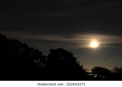 Moon Behind Some Clouds. Night Photo. Dark Forest Silhouette. Järfälla, Stockholm, Sweden, Scandinavia, Europe.