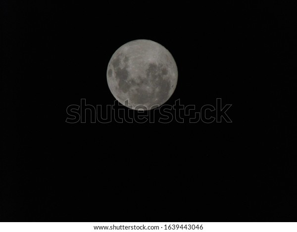 the moon in black space\
full moon