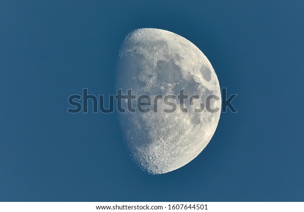 The Moon\
in blue daylight sky, waxing gibbous\
phase