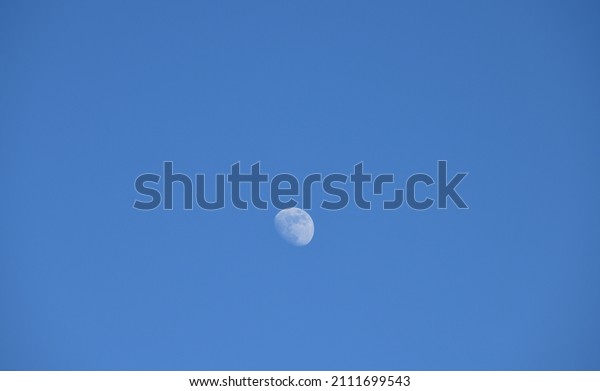 the moon in blue sky in Alicante province, Costa Blanca,\
Spain 
