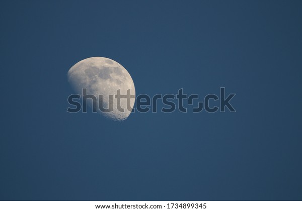 Moon in the blue sky. Crescent moon in front of
the blue sky at sunset.