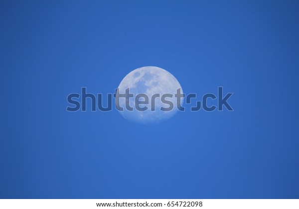 moon at blue sky during\
afternoon