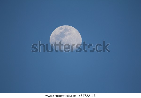 moon at blue sky during\
afternoon