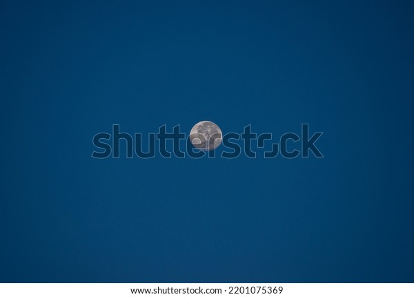 the moon with blue sky\
during sunrise