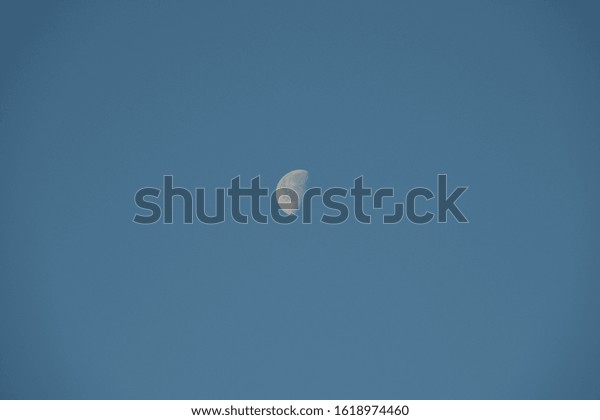 the moon in the blue spanish sky\
in Alicante province, Costa Blanca, Spain, January 17,\
2020