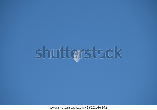 the moon in the blue spanish sky and a\
plane, Alicante Province, Costa Blanca,\
Spain