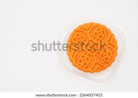 Moon cake in clear plastic tray on isolated background. Traditional Chinese mid autumn festival mooncake.