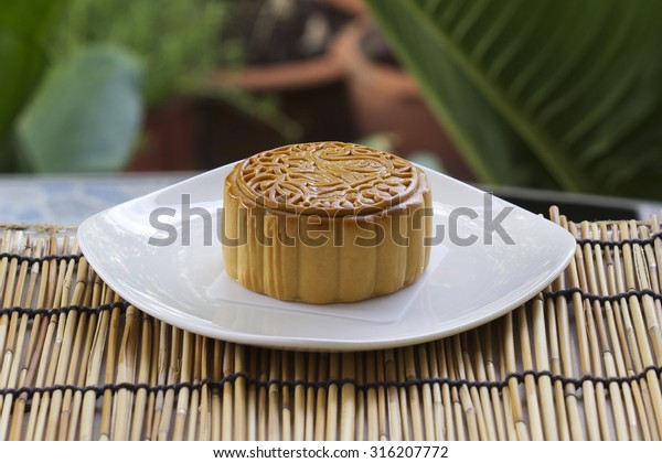 Moon cake with durian and macadamia nut filling on\
the plate