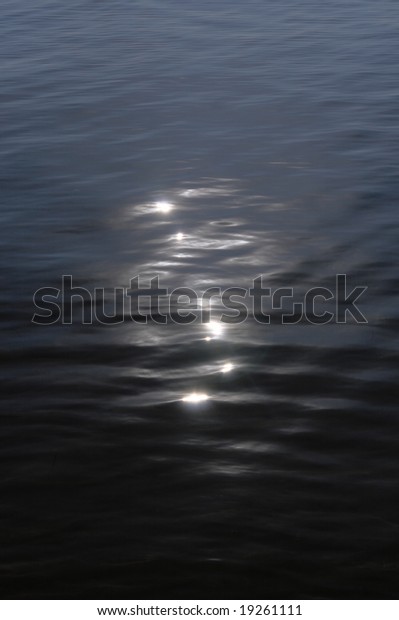 Moon catchlights\
on night sea water surface
