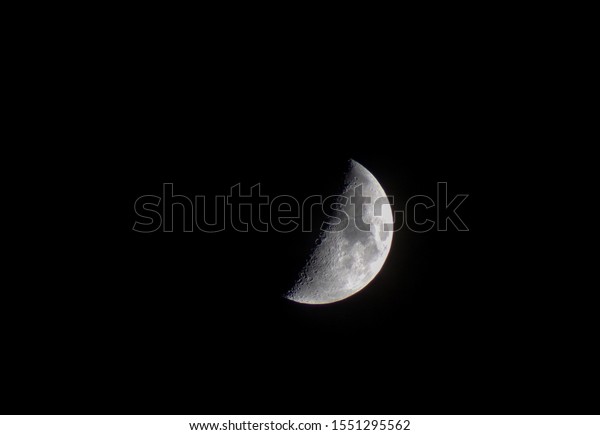The moon is close in the night sky.Month on the\
black the sky.Craters and lakes are clearly visible on the moon.The\
moon is the earth\'s only natural satellite.Moon phase.Background of\
the month.