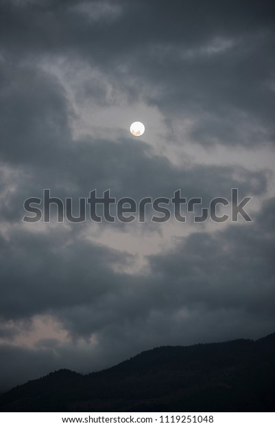 the moon in the\
clouds