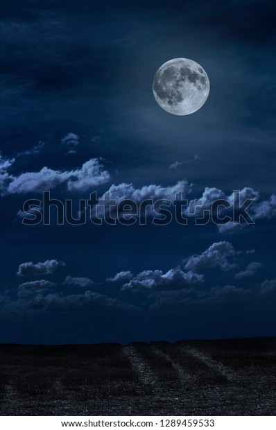 Moon and clouds in the night. Moonlight and\
road background. Dark blue\
backdrop.