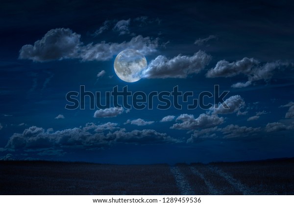 Moon and clouds in the night. Moonlight and\
road background. Dark blue\
backdrop.