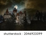 Moon in the clouds over Bran Castle, Transylvania, Romania. Medieval building, Dracula