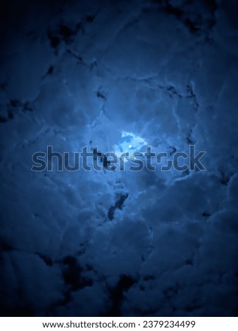 The moon is covered by clouds at night