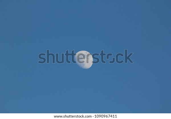 The moon in the\
daytime.
