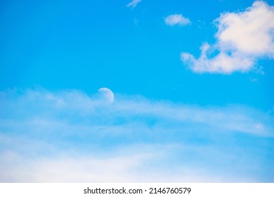 the moon is in the daytime sky. cloudy sky. close-up