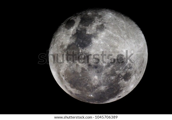 Moon detail / The Moon is an astronomical body
that orbits planet Earth, being Earth's only permanent natural
satellite. It is the fifth-largest natural satellite in the Solar
System, and the largest 