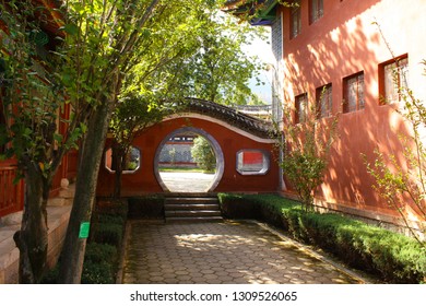 Moon Gate In A Traditional Chinese House, Painted With Red Color.