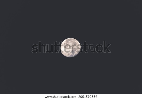 Moon glowing on\
black background. Earth Moon\
