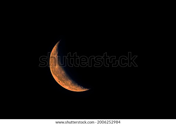 moon in golden light with dark sky ,\
crescent moon detail image in blur background \
