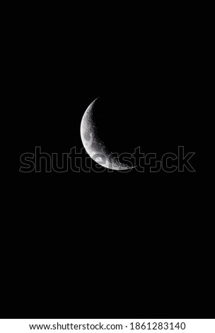 Moon half covered by shadow in the black sky png
