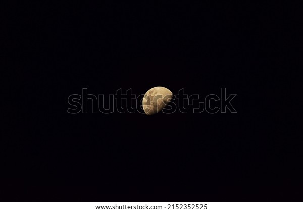Moon with half-shadow In the middle of\
the picture On a cloudless sky Bangkok\
Thailand
