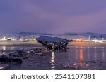 Moon halo, scrapyard of old wooden ships, Teriberka, Murmansk region, Russia, Arctic, polar night