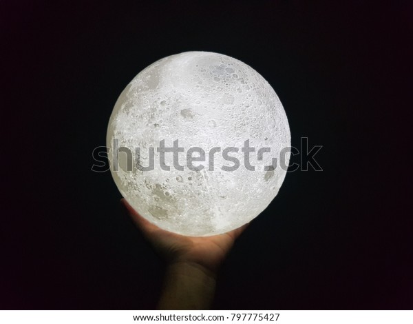 A moon in\
hand