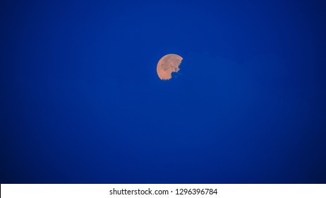 moon hiding behind the clouds