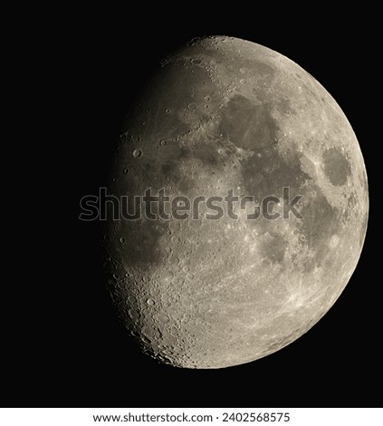 The moon illuminated in waxing gibbous stage, isolated on a black background.