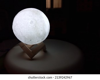 The Moon Lamp On A Small Round Table In A Dark Room