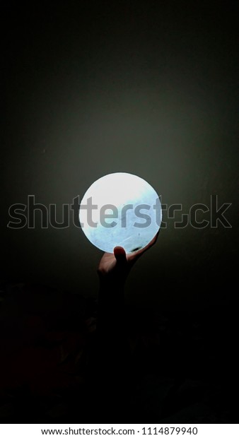 Moon lamp in\
the single hand representing\
success
