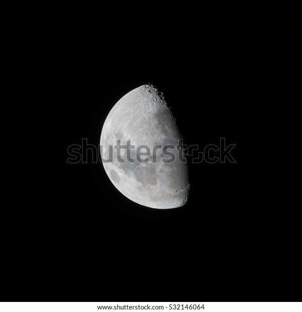 The moon at night isolated on black. the moon is\
half full and its craters are clearly visible.\
The picture was\
take an a clear dark night.