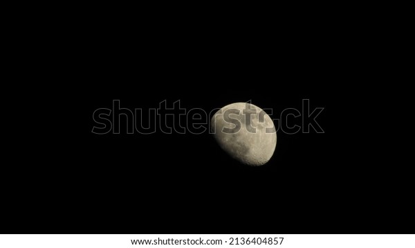 The moon in the night sky. Black lunar background.\
Wallpaper with the moon.