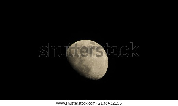 The moon in the night sky. Black lunar background.\
Wallpaper with the moon.