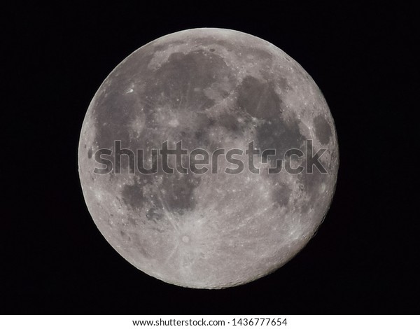 The moon\
in the night sky. Two thirds of the\
moon.