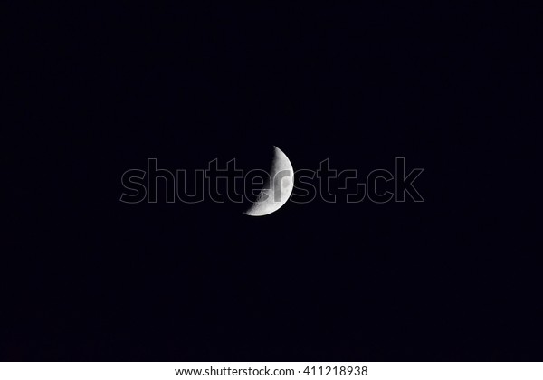 The moon
in the night sky. Two thirds of the
moon.