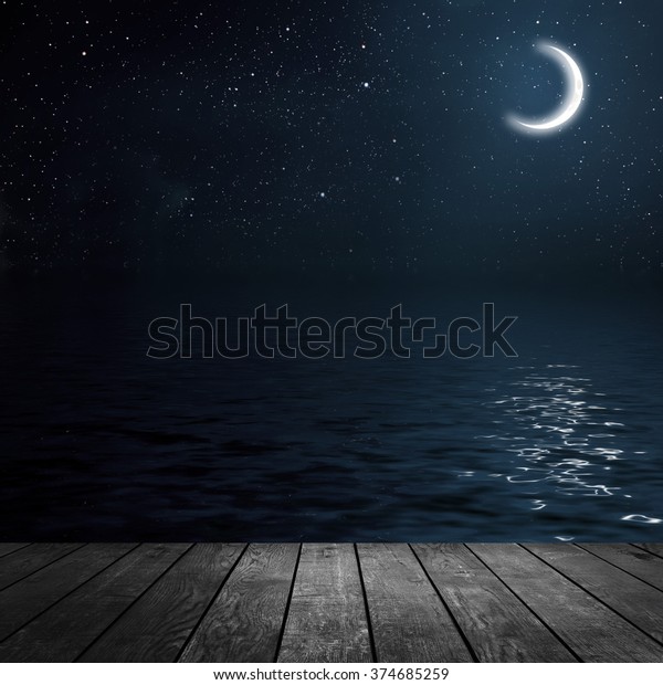 moon\
on a background star sky reflected in the sea.\
wood