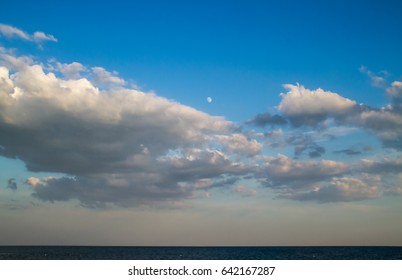 Moon on Blue cloudy sky