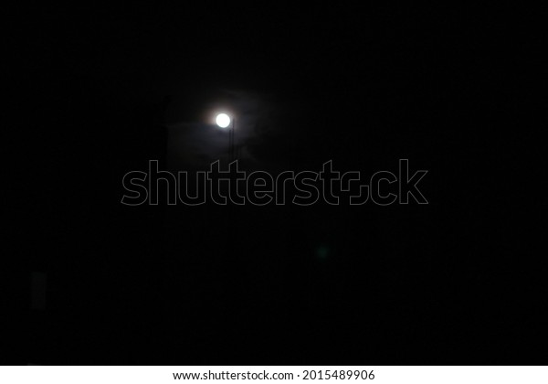 Moon on the dark sky. Real Picture of Moon. The\
Moon without cloud at night. Serenity nature background, outdoor at\
gloaming. Beautiful landscape fantasy. Peaceful sky. Minimalist\
picture of moon.