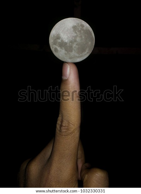 moon on the fingure\
tip touching the moon